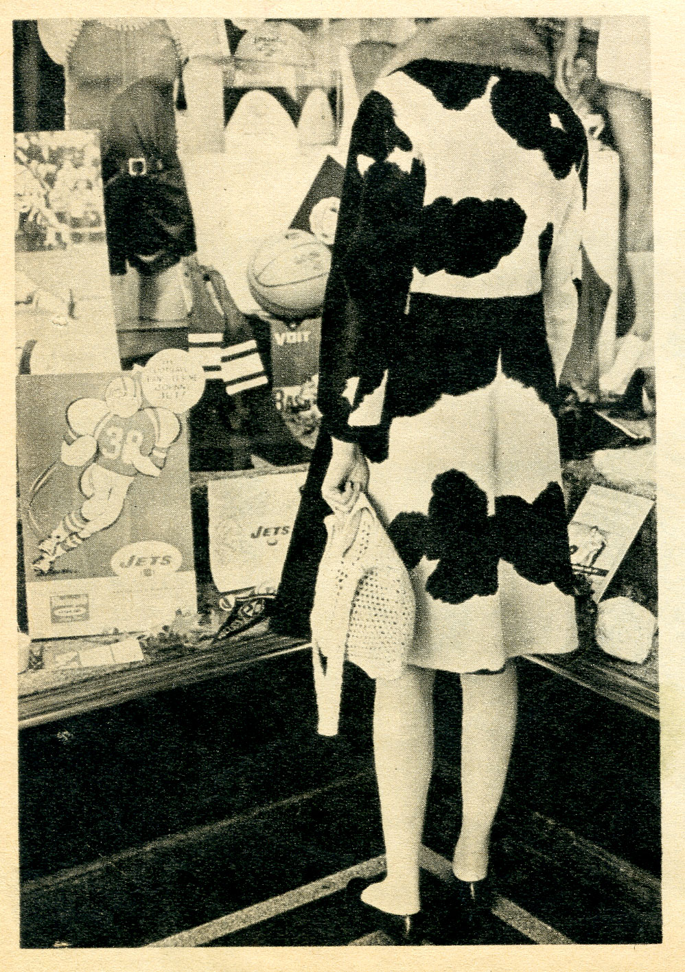 woman in fur coat looking in store window